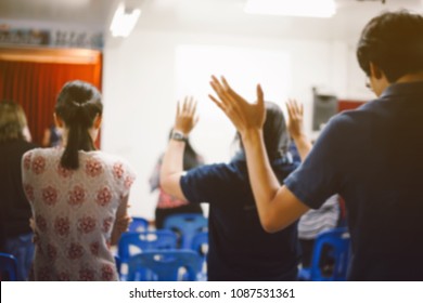 Blurred Christian Worship With Raised Hand At Church