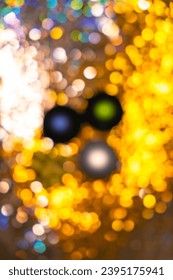 Blurred Christmas and New Year theme background with glowing and sparkling elements. - Shutterstock ID 2395175941