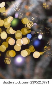Blurred Christmas and New Year theme background with glowing and sparkling elements. - Shutterstock ID 2395213991
