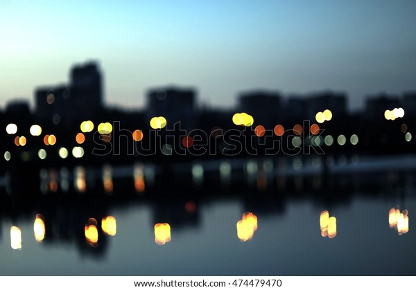 blurred\
city, spot lights and cars on the evening\
city