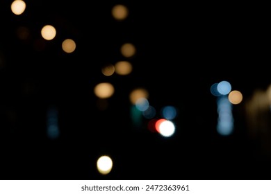 A blurred city street image at night. Abstract blur urban city street road with lighting bokeh for background. - Powered by Shutterstock