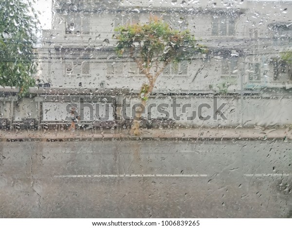 Blurred cityscape in\
raining, In car view