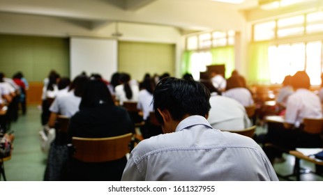 Blurred Classroom Of Students Taking Exam At The Test Center, Selective Focused Picture Of Learners Participating The Lecture Hall, Education Or Academic Concept Image Related To College Or University