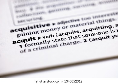 Blurred close up to the partial dictionary definition of Acquit