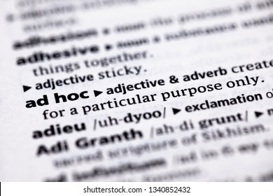 Blurred close up to the partial dictionary definition of Ad Hoc