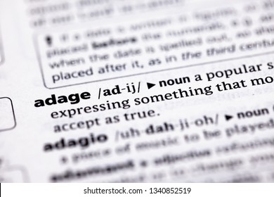 Blurred Close Up To The Partial Dictionary Definition Of Adage