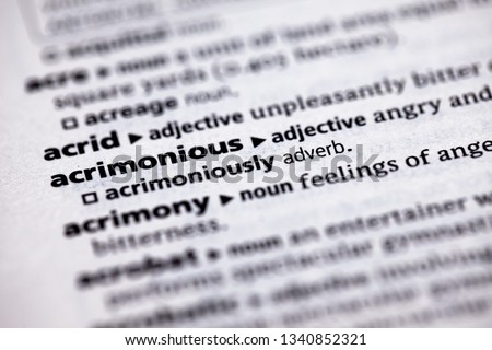 Blurred close up to the partial dictionary definition of Acrimonious