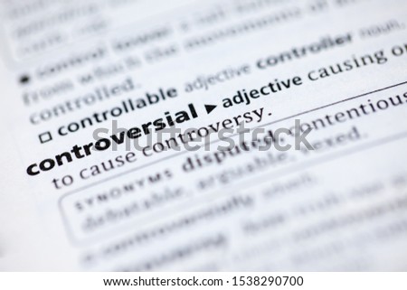 Blurred close up to the partial dictionary definition of Controversial