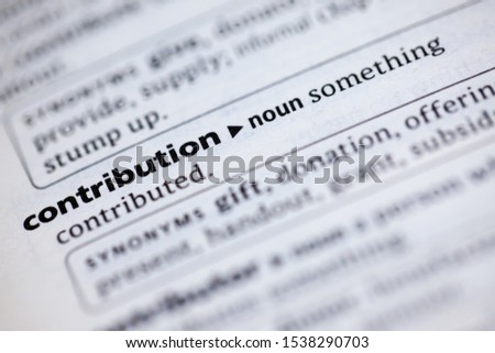 Blurred close up to the partial dictionary definition of Contribution