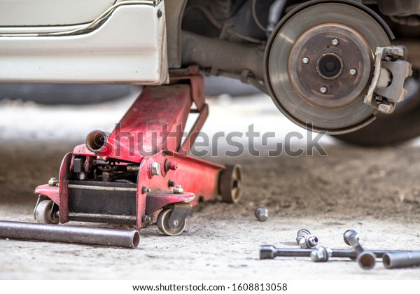 Blurred up close view of car maintenance, tire\
changing, disk brake cleaning, for the safety of the driver and\
maintenance according to the\
use.