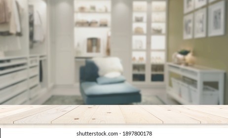 Blurred  Closet In The Room Background And Wooden Table Top In Front For Montage Or Display Your Products