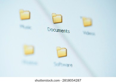 Blurred close-up of a computer desktop highlighting a 'Documents' folder icon, suggesting digital file organization, document management, and computer workflow for office, home, and productivity use.