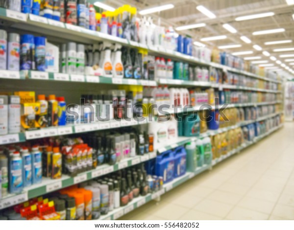 Blurred colorful motor oil bottles on shelves\
in supermarket as\
background