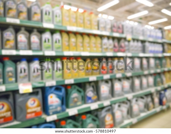 Blurred colorful motor oil bottles on shelves\
in supermarket as\
background