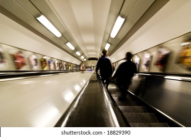 Blurred couple commuting between subway stations