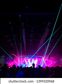 Blurred Crowd At Concert : Silhouette People Crowd Happy And Cheering In Front Of Colorful Stage With Bright Laser Light Beam. Music Superstar Performance. Soft Focus