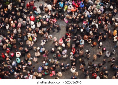 Blurred crowd of people in multicolored clothes in the city. Top view - Shutterstock ID 525036346