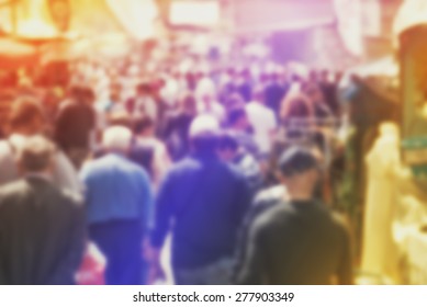 Blurred Crowd Of People On Street, Unrecognizable Crowded Population As Blur Urban Background, Vintage Toned Image.