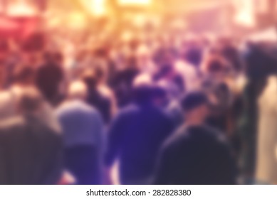 Blurred Crowd Of People On Street, Unrecognizable Crowded Population As Blur Urban Background, Vintage Toned Image.