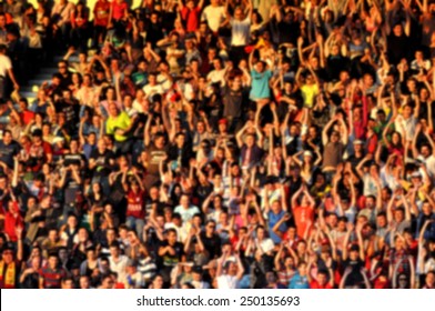 Blurred Crowd Of People In A Stadium