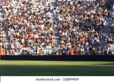 Blurred crowd of spectators on a stadium tribune at a sporting event