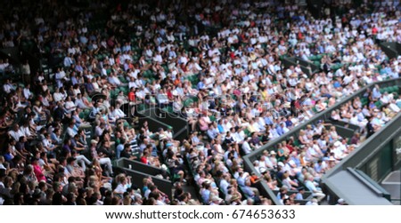 Blurred crowd spectators watching the tennis match at Centre Court, Wimbledon. 