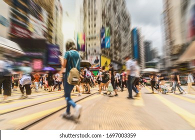 Blurred Crowd of Traffic car and tram with Unrecognizable pedestrians walking around crossing Central District in rush hour working day, Hong Kong, blur business and people of Pedestrian concept