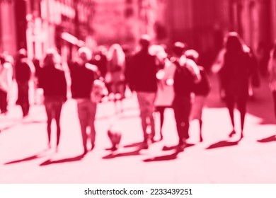 Blurred crowd of walking people in the city with buildings in the background. red toning. Demonstrating Viva Magenta - trendy color of the year 2023 - Shutterstock ID 2233439251