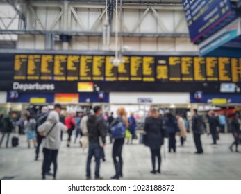 Blurred Of Crowded Passengers In Waterloo Looking At The Timetable. London Waterloo Is Britain’s Largest And Busiest Station On The National Rail Network In The UK