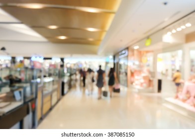 Blurred Crowded People Walk At The Shopping Mall Hallway Background.