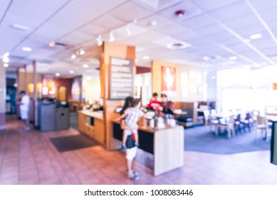 Blurred Customers Ordering From Kiosk, Digital Interfaces For Menu Browsing. Abstract Background Interior Of Counter-serve Bakery, Cafe Chain Shop In America. Vintage Tone.