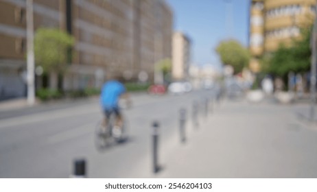 Blurred cyclist riding on an urban street with buildings and cars in the background on a sunny day - Powered by Shutterstock