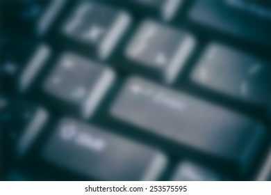 Blurred dark computer keyboard close-up