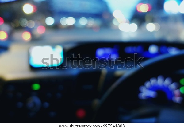 blurred of dashboard car with background bokeh\
from the car lights.