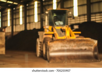 Blurred and de-focus Close up Wheel Loader in a building in a coal fired power plant