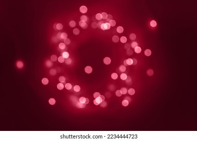 Blurred defocused abstract magic fairy light glitter by Christmas lights on dark magenta background. Toned in color of year 2023 Viva Magenta - Powered by Shutterstock