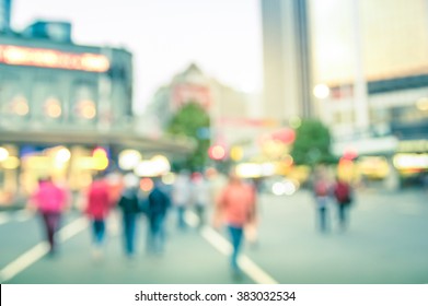 Blurred Defocused Background Of People Walking On Auckland City Streets - Abstract Bokeh Of Crowded Queen Street In New Zealand Capital At Rush Hour - Vintage Filter And Slight Tilted Composition