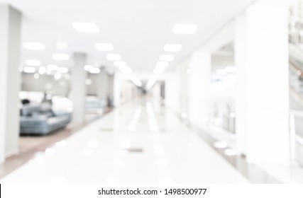 Blurred Defocused Bokeh Background Of Exhibition Hall Or Convention Centre Hallway. Business Trade Show Modern White Interior Architecture. Abstract Blur Modern Business Office Background