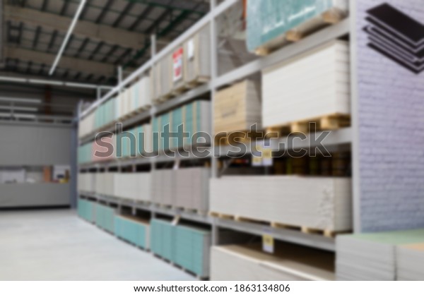 blurred and defocused:\
hardware store with counters of gypsum fiber sheet from different\
manufacturers