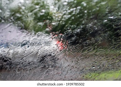 Blurred defocused image of a car driving through heavy torrential rain Rainfall flash flooding warning