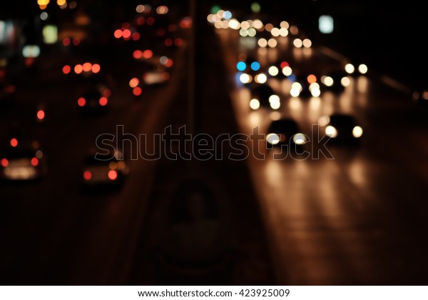Blurred defocused lighting on the road at\
night for background