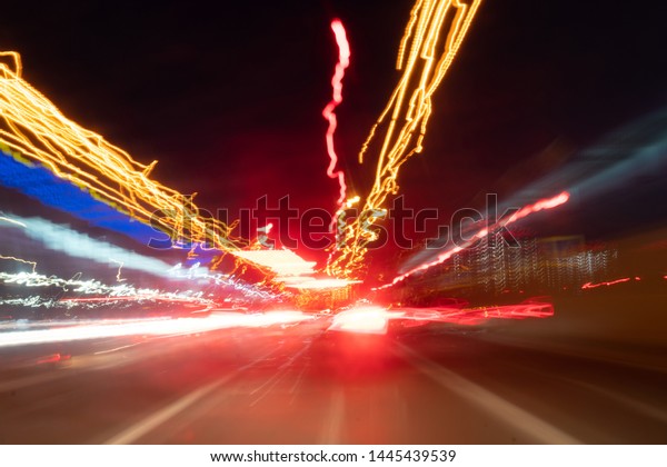 Blurred Defocused Lights of Heavy Traffic on\
a Wet Rainy. traffic lights in motion\
blur.