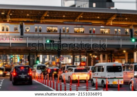 Blurred defocused Metro Train passing over traffic jam on overpass in Meguro district during rush hour. Method of Transportation and Mass Transit concept.