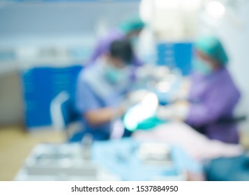 Blurred dentist and assistant examining patient tooth on dental chair at dental department.Medical mouth and tooth health care concept.