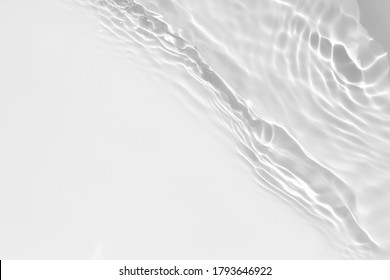 Blurred desaturated transparent clear calm water surface texture and splashes   bubbles  Trendy abstract nature background  White  grey water waves in sunlight 