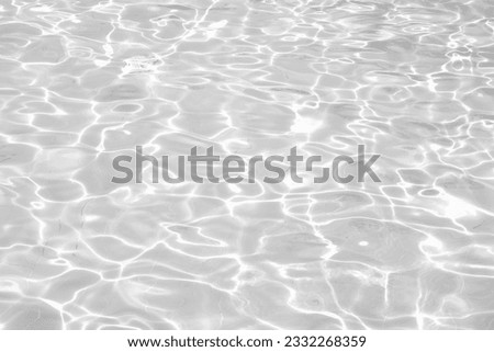 Blurred desaturated transparent clear calm water surface texture with splashes and bubbles. Trendy abstract nature background.
