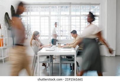 Blurred designers, marketing or freelance professionals working together in a modern office. Business men and women busy, walking and active in a creative workplace, workstation or environment