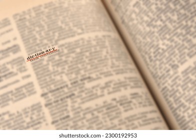 Blurred  dictionary page close up with underlined word
