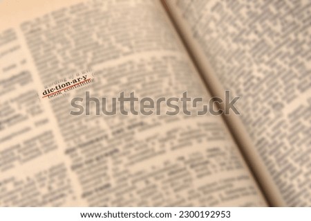 Blurred  dictionary page close up with underlined word