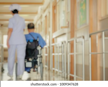 Blurred, Disabled Elderly Sitting In A Wheelchair With Nurse At The Veterans General Hospital